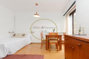 a bedroom with a table and a bed and a mirror at Mikka-TREMOL LUXE 33 in El Tarter