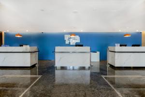 a room with blue walls and white desks at Holiday Inn Express Shanghai Chongming, an IHG Hotel in Chongming