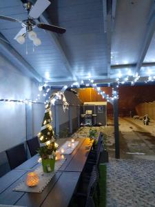 a long table with a christmas tree and lights at Butella Apartman Eger in Eger