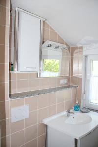 a bathroom with a sink and a window at FeWo am Schlossberg in Neusitz