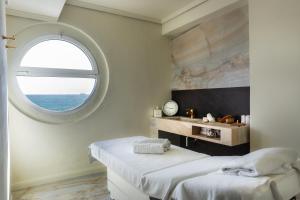 a bedroom with two beds and a window at Excelsior Palace Portofino Coast in Rapallo