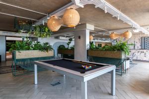 a pool table in the middle of a room at Wex 1 Apartments in Cape Town