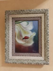a painting of a bird in a white flower at Guest House near Kolonnady in Kislovodsk