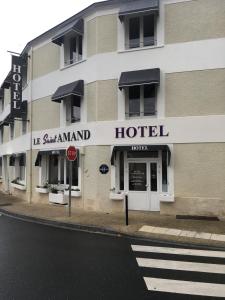 a hotel on the corner of a street at Hôtel Le Saint Amand in Saint-Amand-Montrond