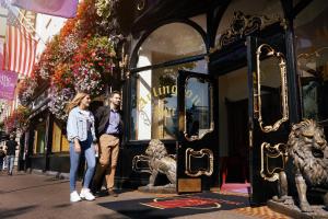 a man and a woman standing in front of a store at Arlington Hotel O'Connell Bridge in Dublin