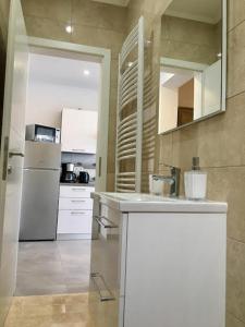 a kitchen with a white counter and a refrigerator at Apartments Perić in Jelsa