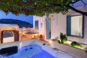 a swimming pool in the middle of a house at Lindos Beach Boutique Villa in Lindos