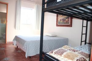 Krevet ili kreveti u jedinici u okviru objekta Casa para temporada com 3 suítes com ar condicionado