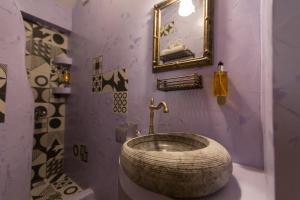 a bathroom with a large wooden sink in a room at Maria's Boutique Rooms in Kórinthos