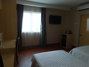 Postel nebo postele na pokoji v ubytování Metro Hotel @ KL Sentral
