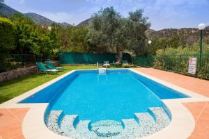 a swimming pool in the backyard of a house at Villa Apelia - Family Holidays Deals in Vlikhádha +19 photos