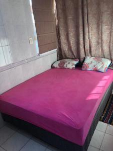 a large purple bed with two pillows on it at Ap 408 Beira Mar - Pés na areia in Capão da Canoa