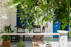 a table and chairs in a courtyard with plants at Grandma's Chic Home in Chania Venetian Harbor in Chania