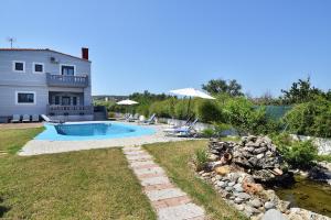 a backyard with a swimming pool and a house at Villa Vassiliki in Kolymvari