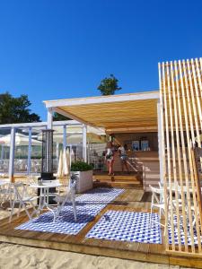 ソポトにあるSopot 34 przy plażyのデッキ(椅子、テーブル付)、パビリオン