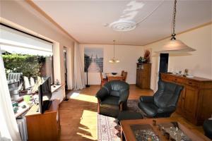 a living room with two chairs and a television at Haus-Gabriele in Haßberg