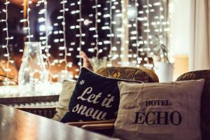 a table with pillows on a table with lights at Hotel Echo in Bad Gastein