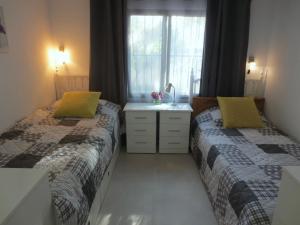 Łóżko lub łóżka w pokoju w obiekcie Clubrent - Townhouse La Merced