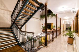 a staircase in a building with potted plants at Hotel Valdivia Plaza in Jardin