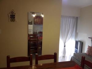 a living room with a table and a dining room at Depto en La Vicente! in Olavarría +19 photos