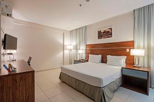 a hotel room with a bed and a television at Slaviero Porto Velho in Porto Velho +41 photos