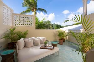 a living room with a white couch and some plants at Curtain Bluff - All Inclusive in Old Road