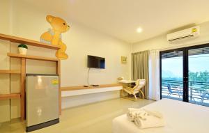 a hotel room with a teddy bear on the wall at Tairada Boutique Hotel in Krabi