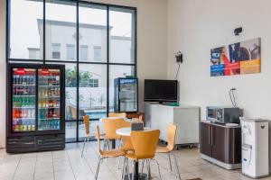 a restaurant with a table and chairs and a drink cooler at Motel 6-Gardena, CA - South in Gardena