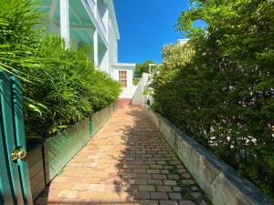 a brick path in front of a white house at The Bartlum by Brightwild-Luxurious Studio in Key West