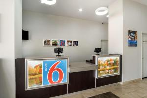 a gas station with a counter with a number six at Motel 6-Lexington, KY - Airport in Lexington