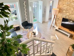 a living room with a table and a tv at Home Out City Villa in Lisbon