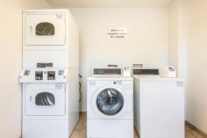 a laundry room with two machines and a washer and dryer at Motel 6-Longview, TX in Longview