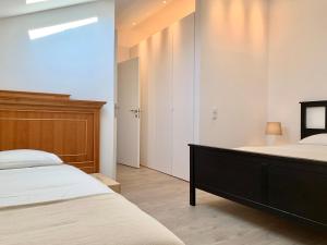 a bedroom with a large bed and a wooden headboard at Home Out City Villa in Lisbon