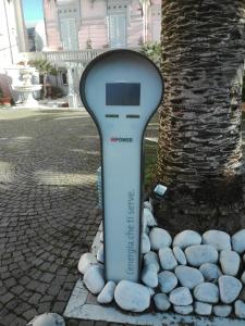 a remote control sitting in a pile of rocks next to a tree at Hotel Europa in Lido di Camaiore