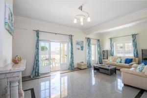 a living room with a couch and a fireplace at Villa Casa Castelo by Algarve Vacation in Albufeira +42 photos