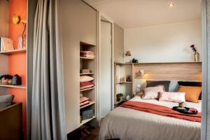 a bedroom with a bed with orange walls at Le Beau Vezé in Carqueiranne +246 photos