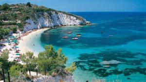 a beach with a bunch of boats in the water at Hotel Acquamarina in Portoferraio