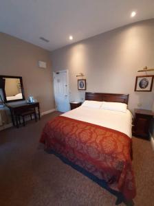 a bedroom with a large bed and a piano at JBs Bar & Guest Accommodation in Kilkenny