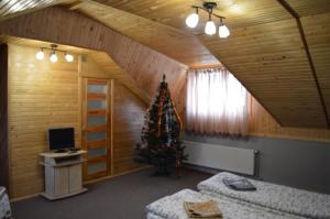 a living room with a christmas tree in a room at Guest House Mansarda in Yaremche