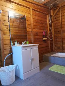 a bathroom with a sink and a bath tub at La maison du nord, T2 privé in Mtsangadoua