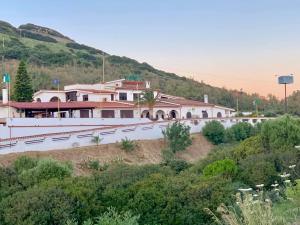 a building on the side of a hill at Tanit Hotel Villaggio Ristorante in Carbonia