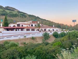 a building on the side of a hill at TANIT Hotel Ristorante Storia del SulcisIglesiente in Carbonia