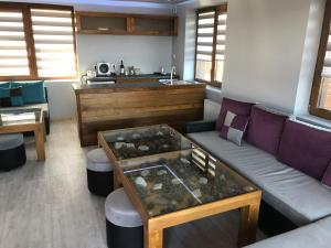 a living room with a couch and a table at RELAX Guest House in Tsigov Chark