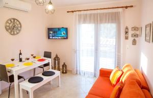 a living room with a couch and a table at Konstantina & Evgenia Deluxe Apartment in Nea Peramos