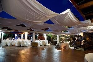a large white tent with white tables and chairs at TANIT Hotel Ristorante Storia del SulcisIglesiente in Carbonia +172 photos