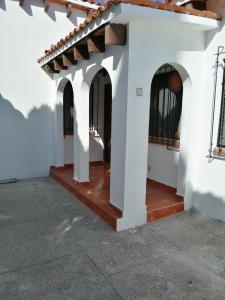 a courtyard of a house with a white building at Villas Tequisquipan in Tequisquiapan