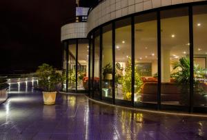 a building with large glass windows and potted plants at Hotel Miracorgo in Vila Real