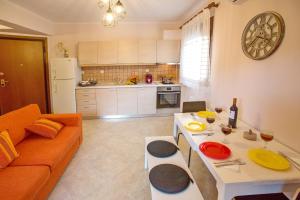 a living room with a couch and a table at Konstantina & Evgenia Deluxe Apartment in Nea Peramos