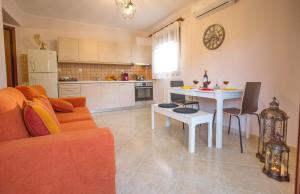 a living room with a couch and a table at Konstantina & Evgenia Deluxe Apartment in Nea Peramos