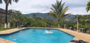 a person in a swimming pool in a resort at Paraiso Inn in Satipo
